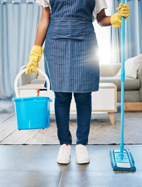 Cleaning bucket and mop with feet of women in living room for hygiene sanitary and disinfection chores cleaner and maintenance with girl with container for bacteria chemical or sanitize routine | Premium Photo