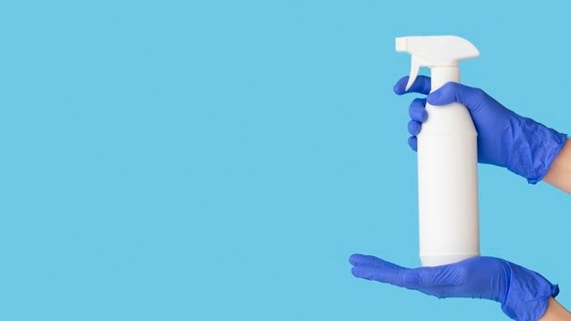 Side view of hands with surgical gloves holding bottle of ablution with copy space | Premium Photo